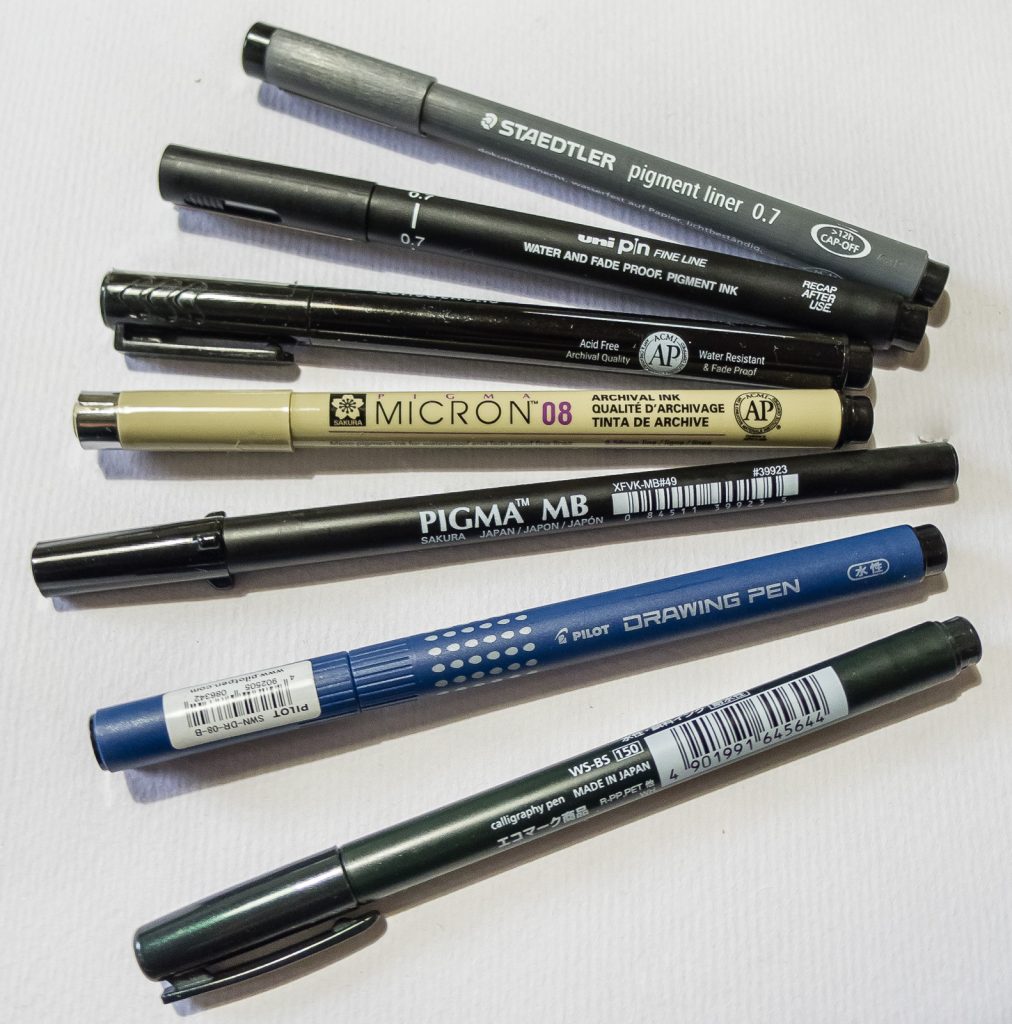 Picture of 7 various fineliner and brush pigment pens.