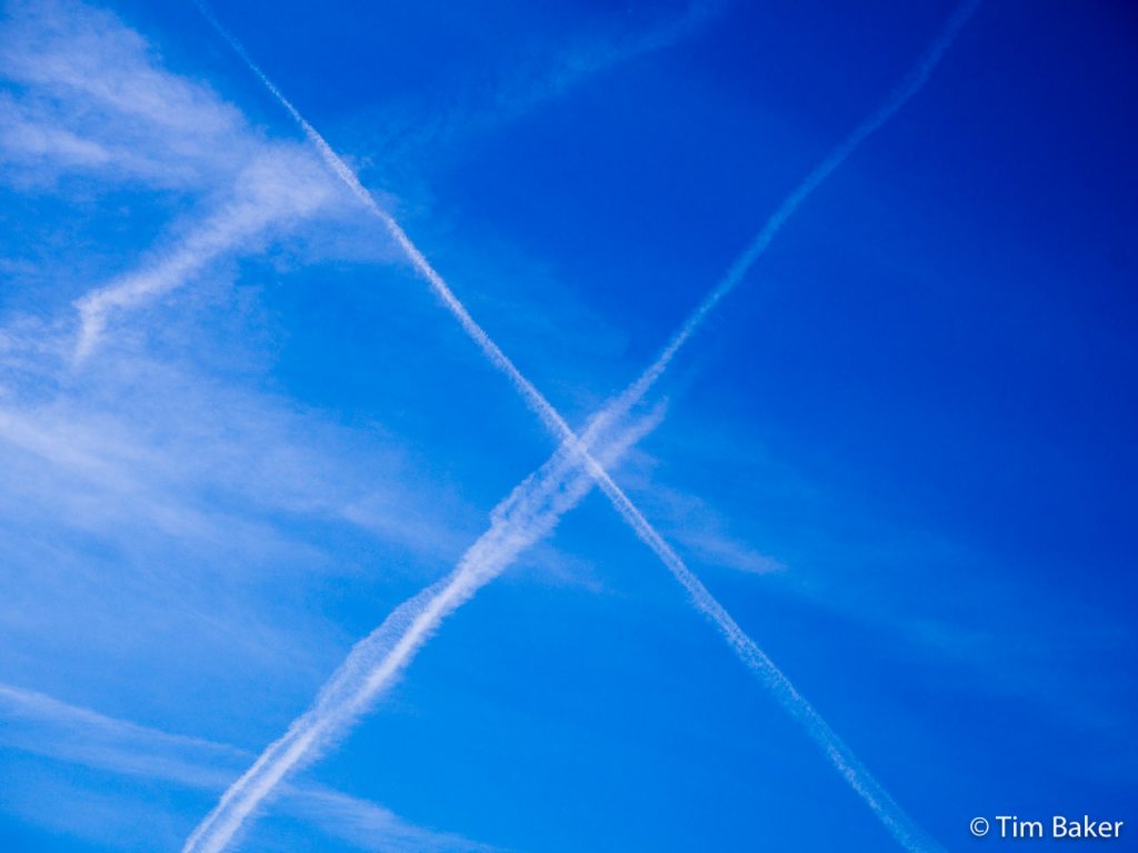 Blue sky with aircraft trails