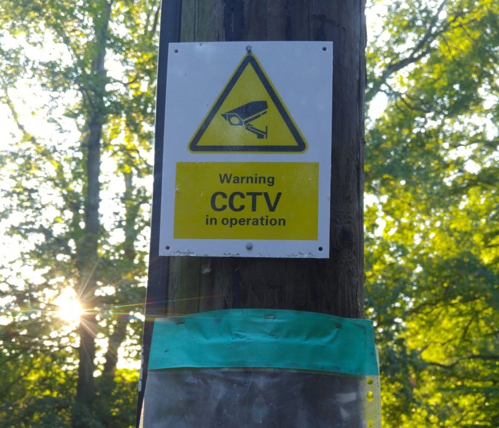 Sign saying 'Warning; CCTV in operation' on Claygate Common
