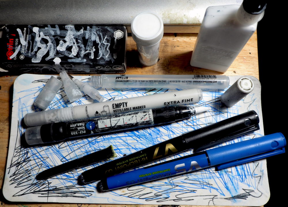 An ethical backpack: Top to bottom: Rotring white ink, Pump fineliners and markers, Posca brushpen (re-used), and the Pilot V5 and V7 Hitechpoint cartridge system.