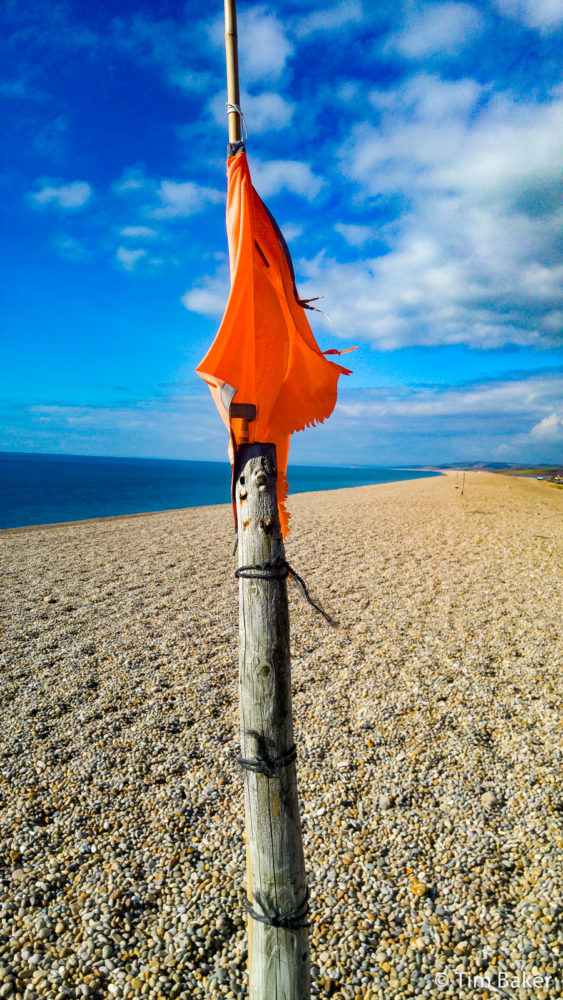 Chesil Beach Red Flag? Or swimming costume? It did seem to be attached so more the former, what it's warning of I don't know.